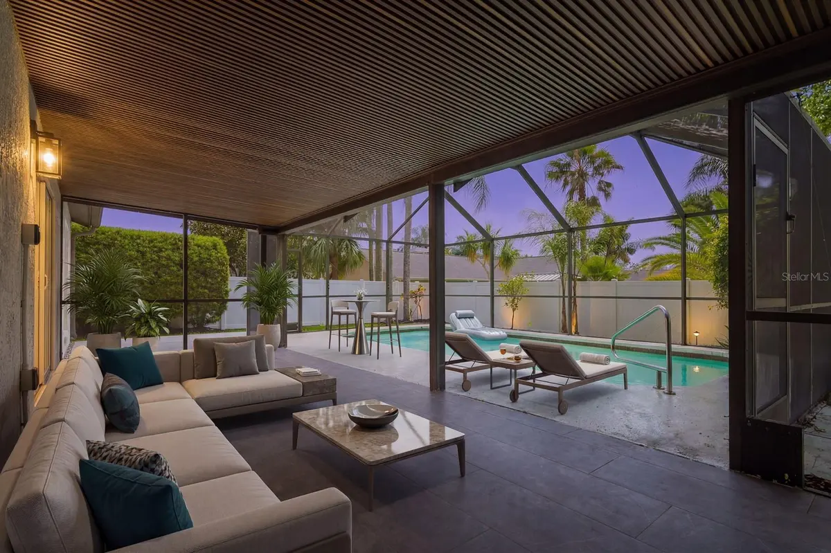 Screened pool and covered patio at a featured Palm Harbor property