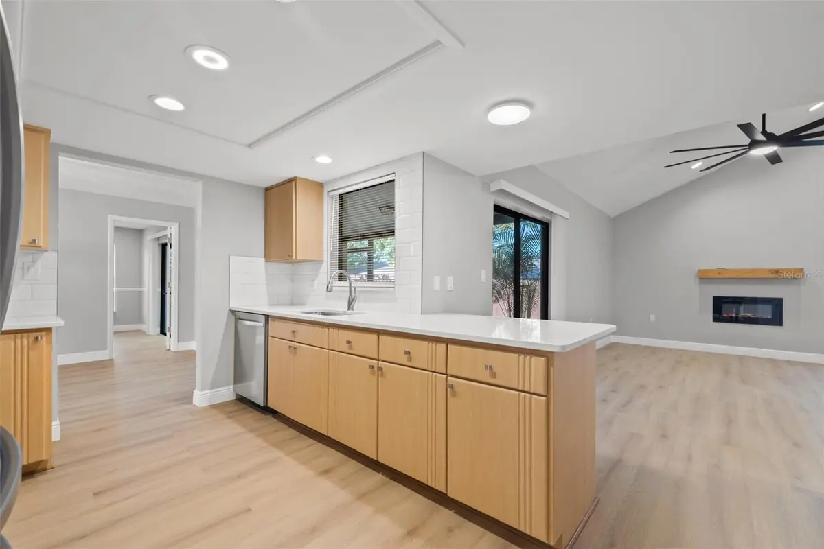 Open kitchen and living interior of a featured New Port Richey property