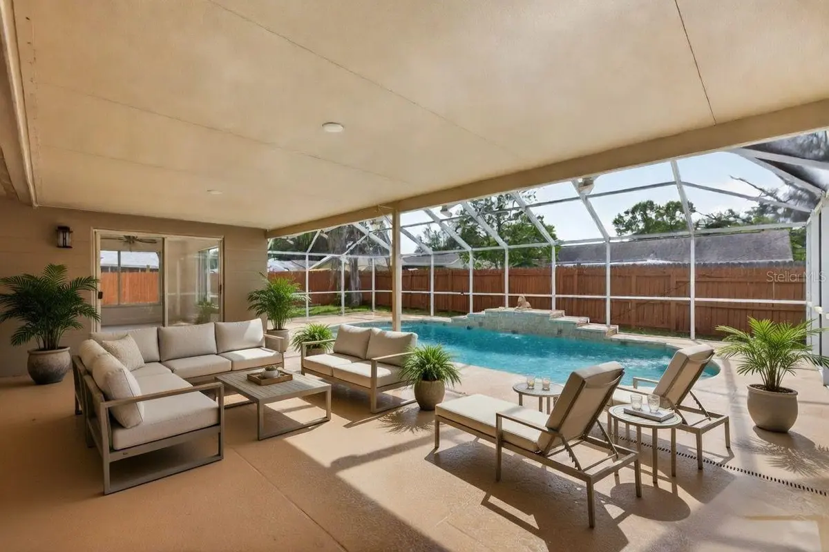 Covered patio and screened pool at a featured New Port Richey property